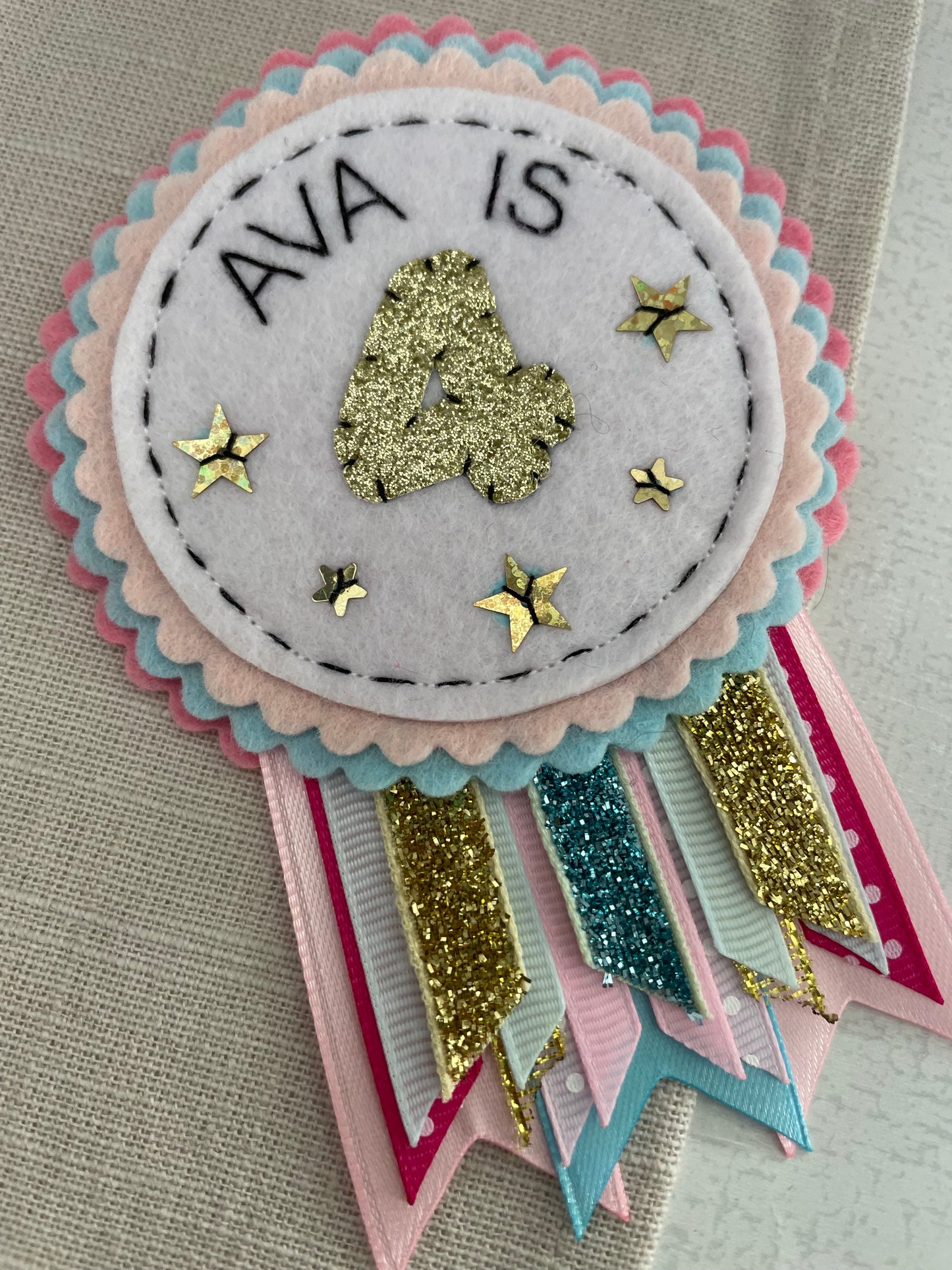 Pastel pink, blue and gold rosette