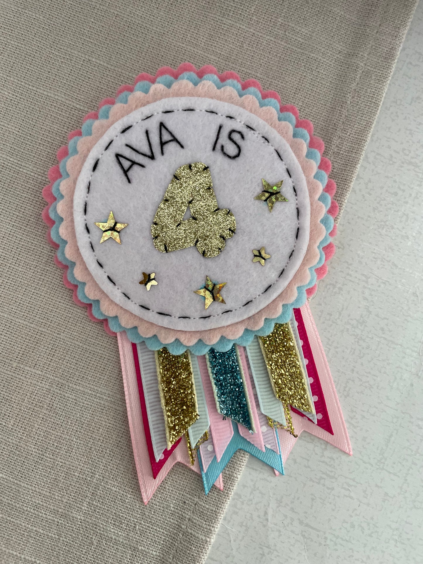 Pastel pink, blue and gold rosette