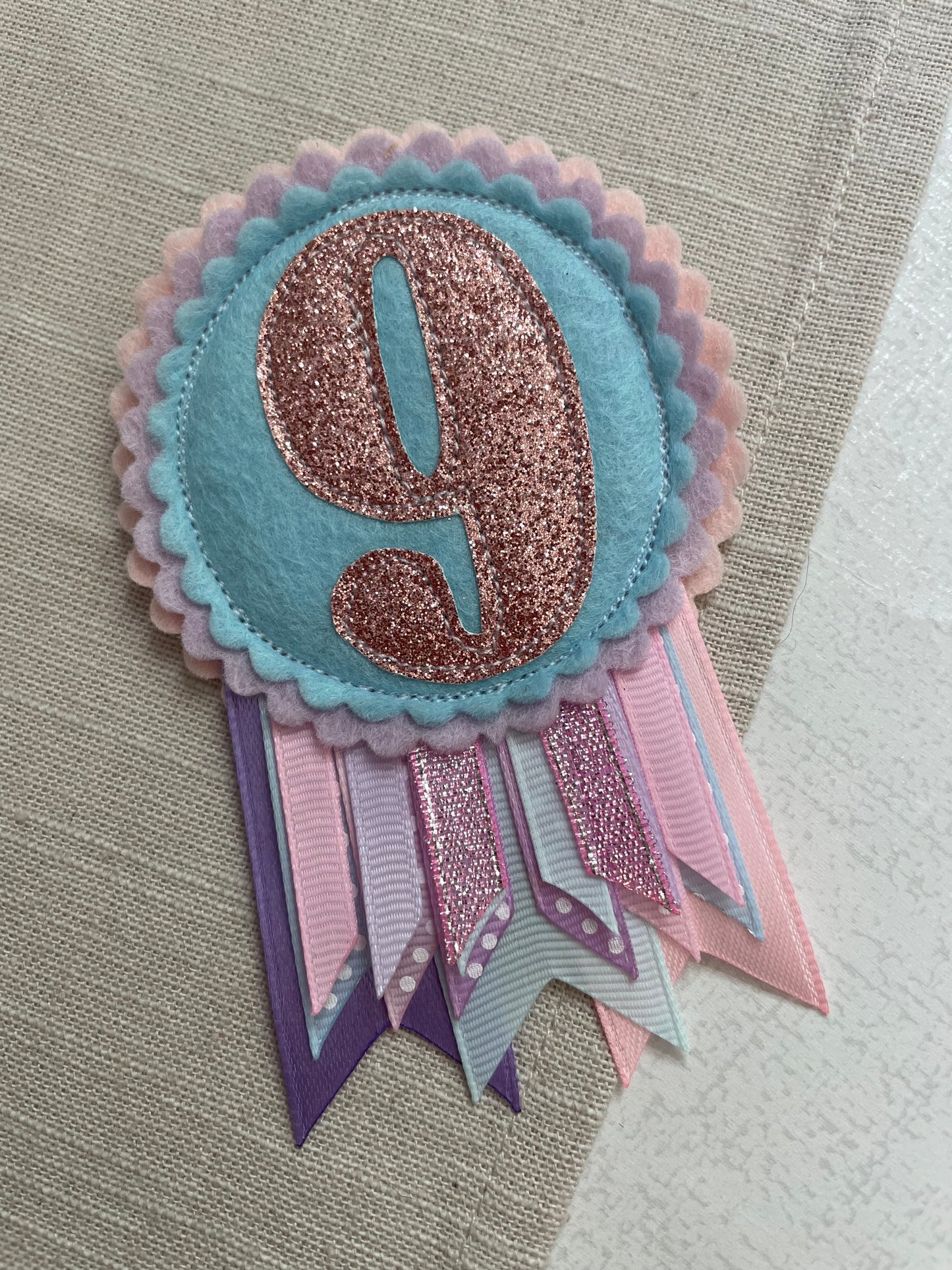 Pastel pink, blue and lilac rosette